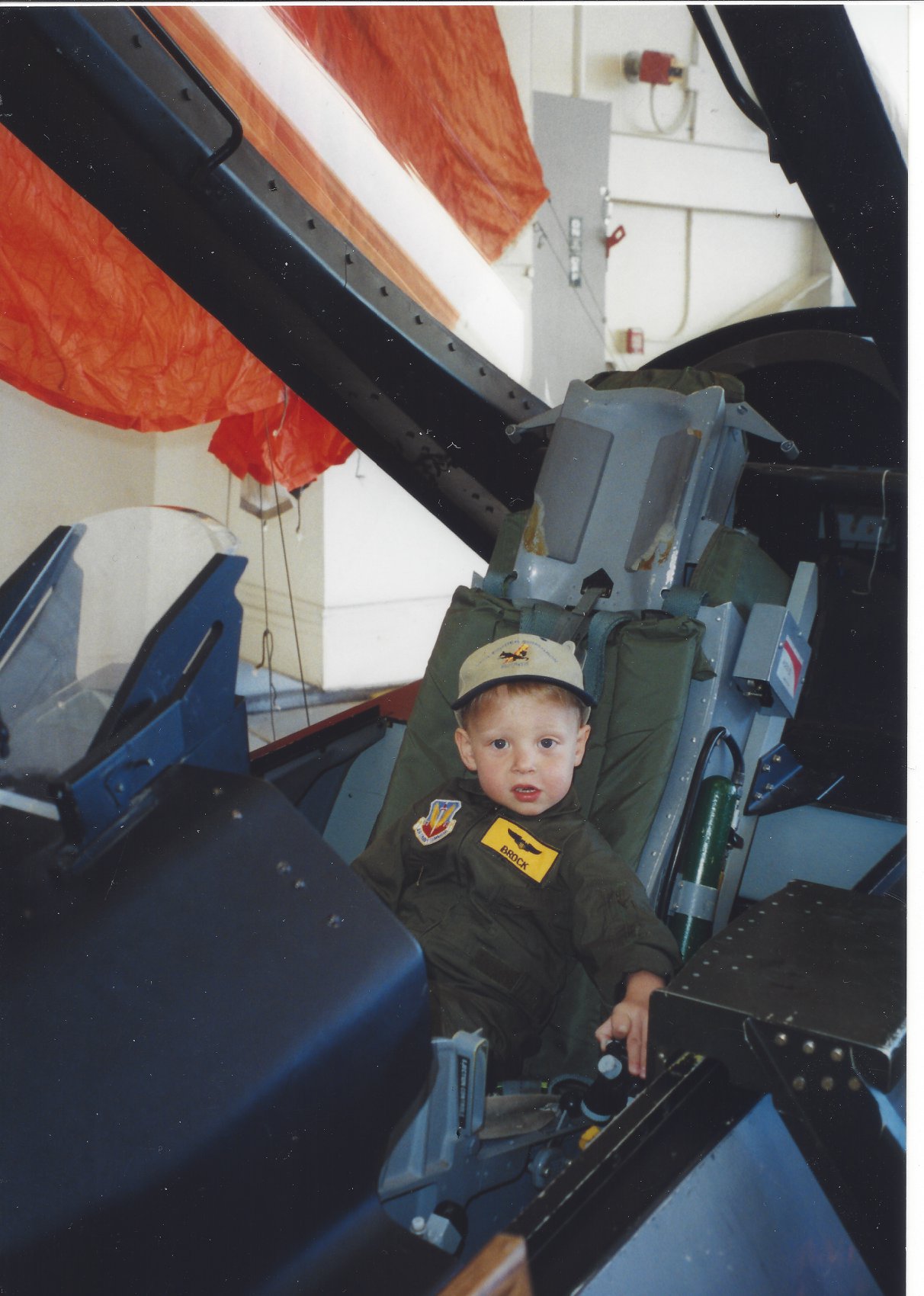 Brock Crawford as a little boy seated in his daddy's fighter jet
