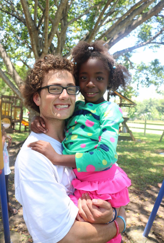 Mitchell Smith '20 with a young girl in the Dominican Republic