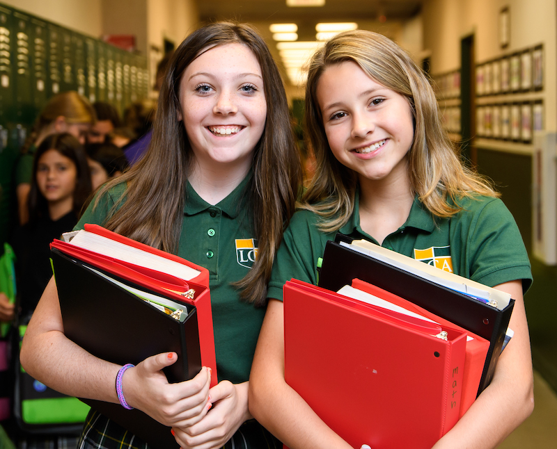 Middle school girls smiling in the hallway of Legacy Christian Academy