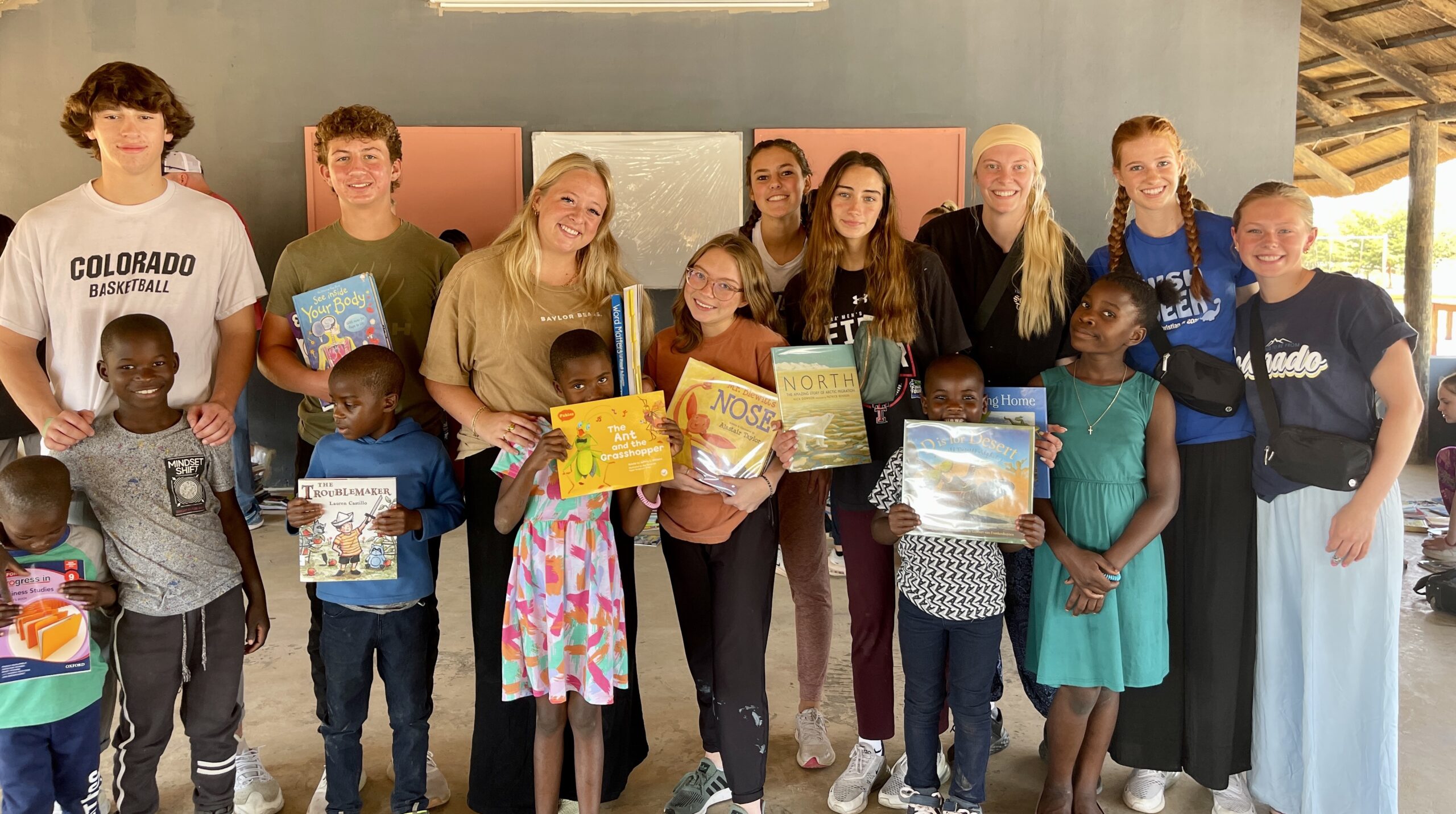 LCA student smiling alongside local children on a Journey trip